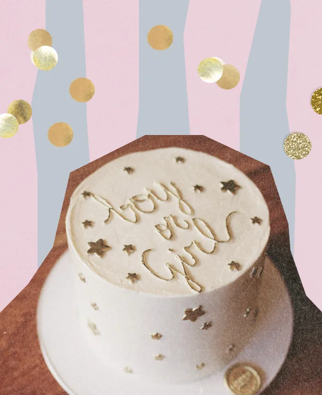 A white cake decorated with "boy or girl" lettering and stars, against a pastel striped background with gold confetti.