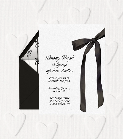 A black and white graduation party invitation with a large black satin bow.